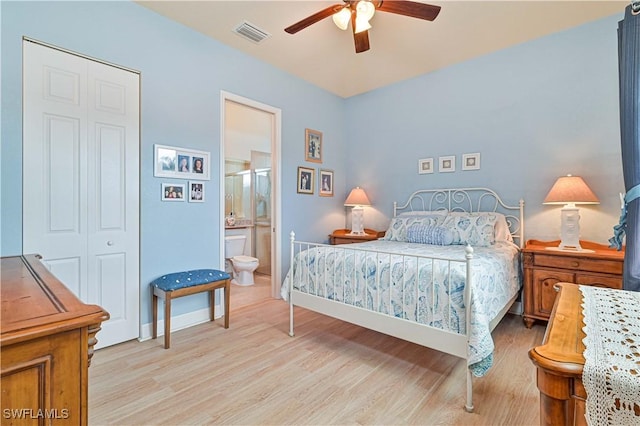 bedroom with a closet, ceiling fan, light hardwood / wood-style flooring, and ensuite bath