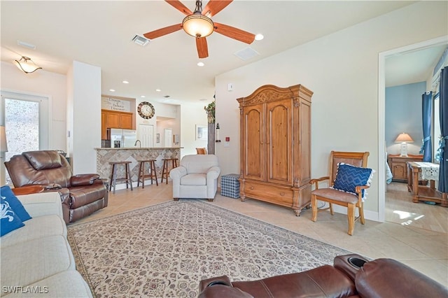 living room with ceiling fan and light tile patterned floors