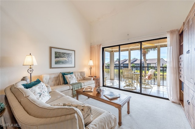 living room featuring light carpet and high vaulted ceiling