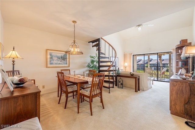 carpeted dining space with ceiling fan