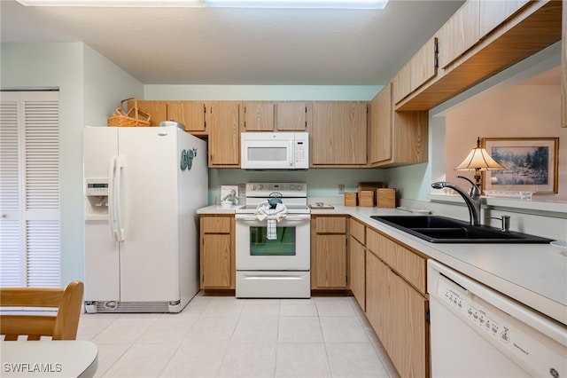 kitchen with light brown cabinetry, white appliances, sink, and light tile patterned floors