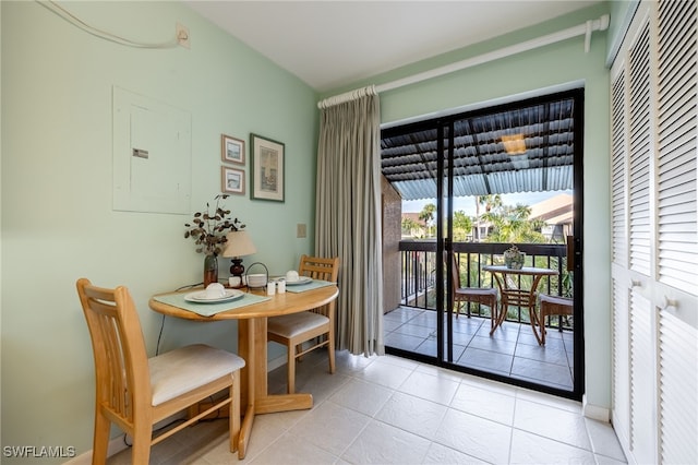 dining area with light tile patterned flooring and electric panel