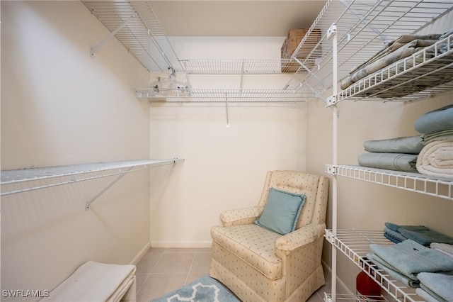 spacious closet featuring light tile patterned floors