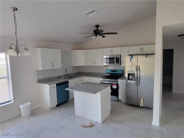 kitchen featuring appliances with stainless steel finishes, a center island, white cabinetry, and hanging light fixtures