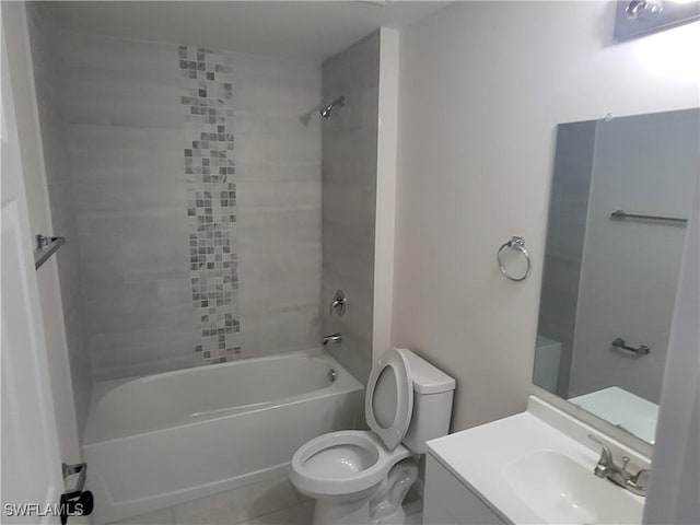 full bathroom with tile patterned floors, vanity, tiled shower / bath combo, and toilet