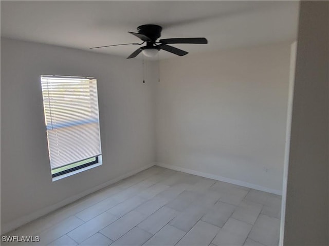 spare room featuring a wealth of natural light and ceiling fan