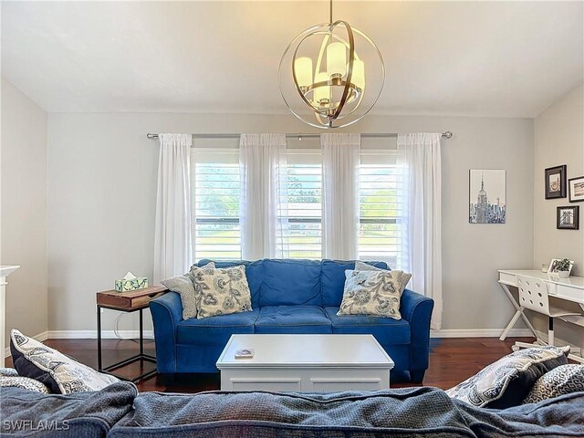 living room with dark wood-type flooring and a chandelier