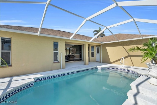 pool with a patio area and glass enclosure