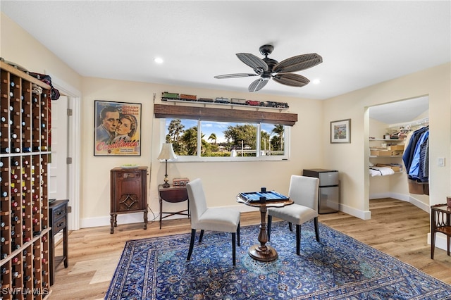 living area featuring light wood-style flooring, baseboards, ceiling fan, and recessed lighting