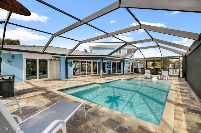 pool with a patio area and glass enclosure