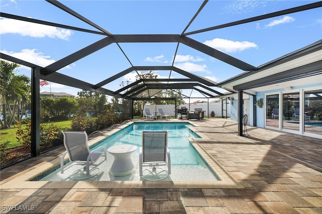 pool with a patio area and a lanai