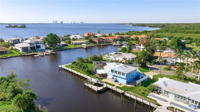 bird's eye view featuring a water view, a residential view, and a pier