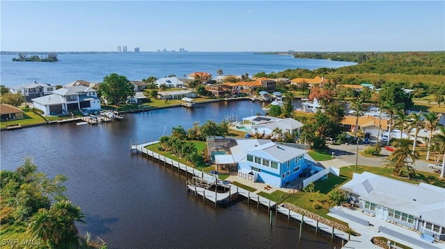 drone / aerial view featuring a pier, a residential view, and a water view