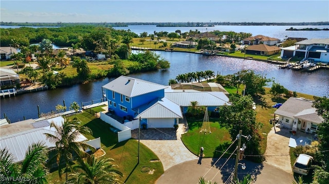 birds eye view of property featuring a water view and a residential view