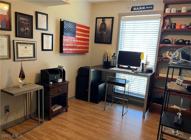 home office with light hardwood / wood-style floors