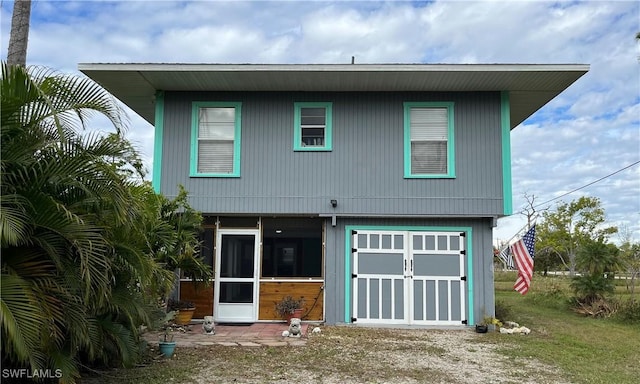 back of house with an outbuilding