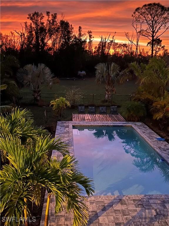 view of pool at dusk