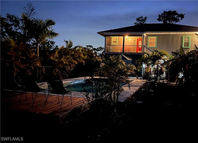 view of back house at dusk