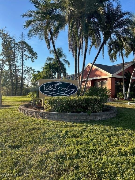 community sign featuring a yard