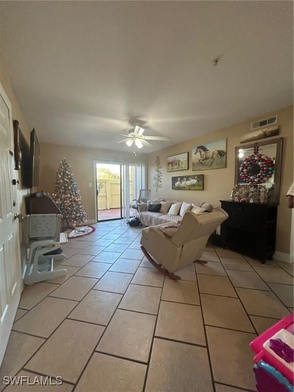 living room featuring light tile patterned floors and ceiling fan