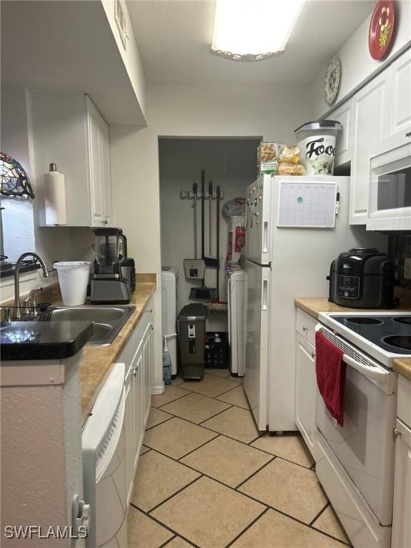 kitchen with sink, white cabinets, and white appliances