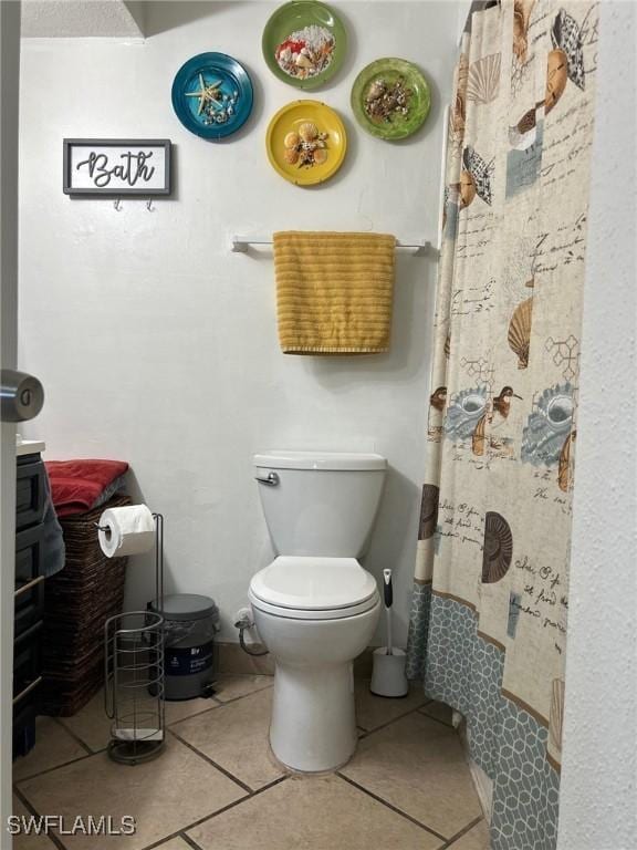 bathroom featuring tile patterned flooring and toilet