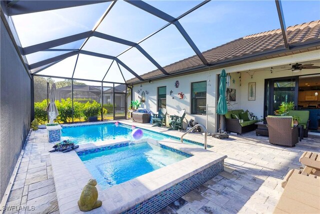 view of pool featuring a lanai, an in ground hot tub, a patio, and an outdoor hangout area