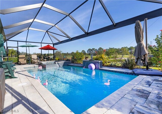 view of swimming pool with glass enclosure, an in ground hot tub, and a patio