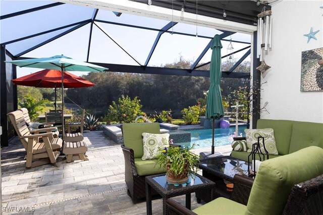 view of patio / terrace featuring glass enclosure and pool water feature