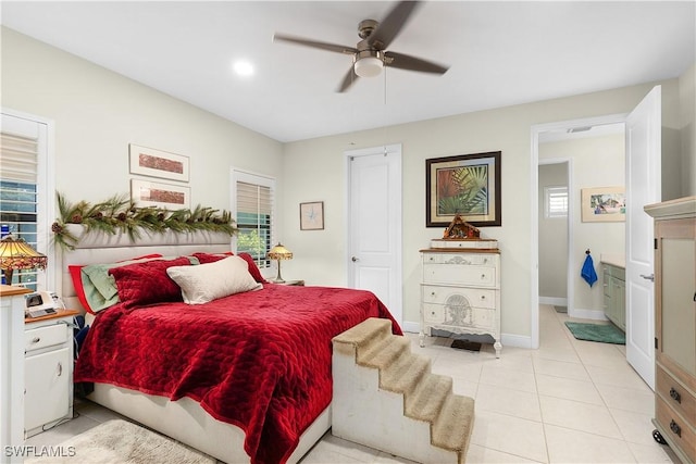 tiled bedroom with connected bathroom and ceiling fan