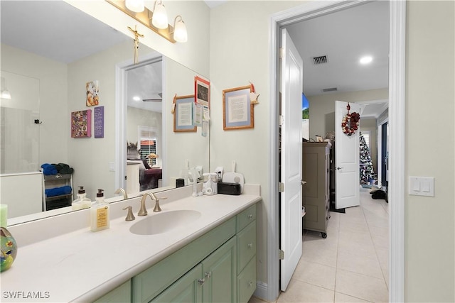 bathroom with tile patterned flooring, vanity, and walk in shower