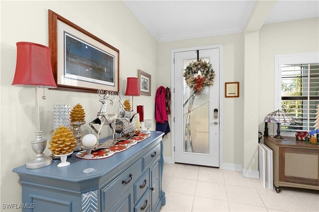 tiled entryway featuring crown molding