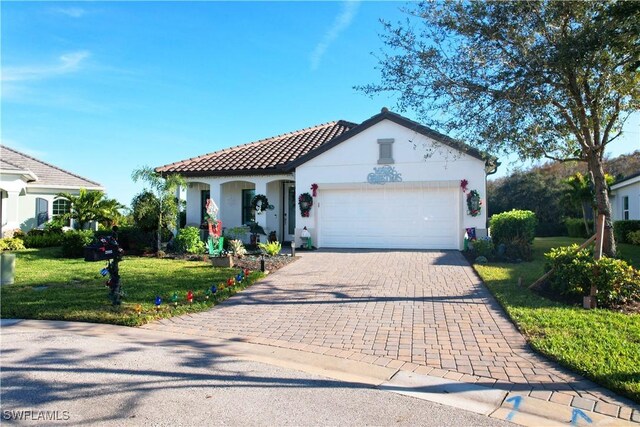 mediterranean / spanish house with a front lawn and a garage