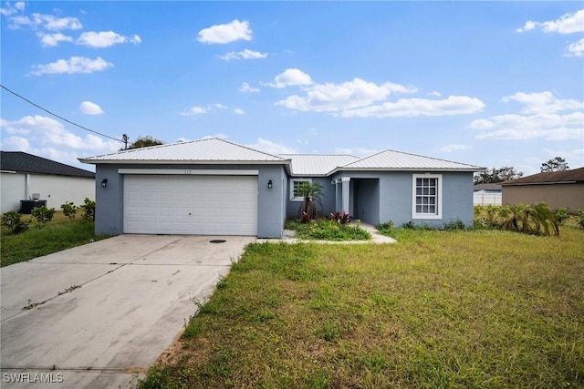 single story home featuring a garage, a front lawn, and central air condition unit