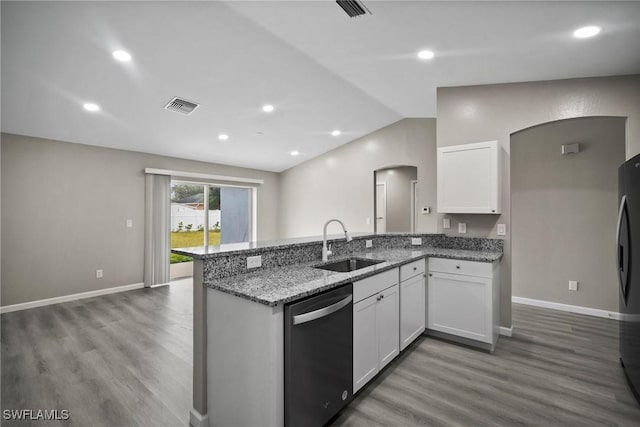 kitchen with stainless steel appliances, vaulted ceiling, sink, wood-type flooring, and white cabinetry