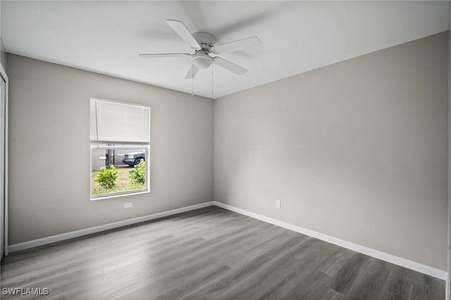 empty room featuring ceiling fan and dark wood-type flooring