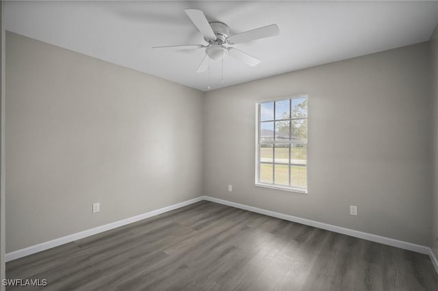 empty room with ceiling fan and dark wood-type flooring