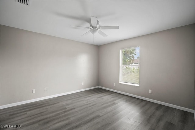 spare room featuring ceiling fan and dark hardwood / wood-style floors