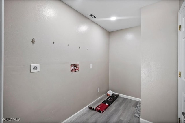 laundry room featuring electric dryer hookup and hardwood / wood-style flooring