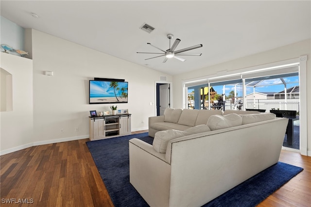 living area with lofted ceiling, visible vents, a ceiling fan, and dark wood-style flooring