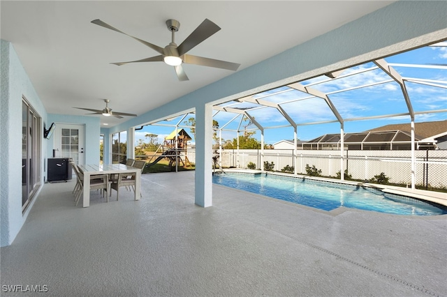 view of pool featuring ceiling fan, a lanai, fence, a fenced in pool, and a patio area