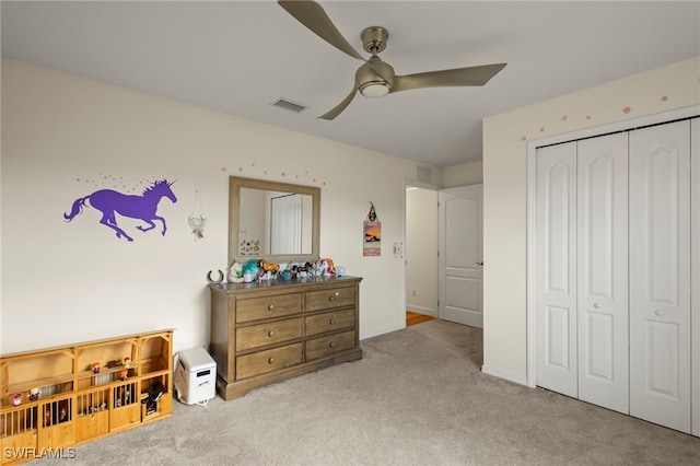 bedroom featuring light carpet, ceiling fan, a closet, and visible vents