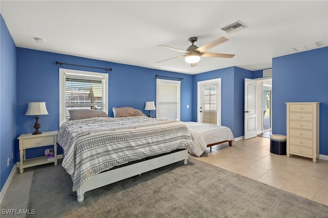 bedroom featuring a ceiling fan, tile patterned flooring, visible vents, and baseboards