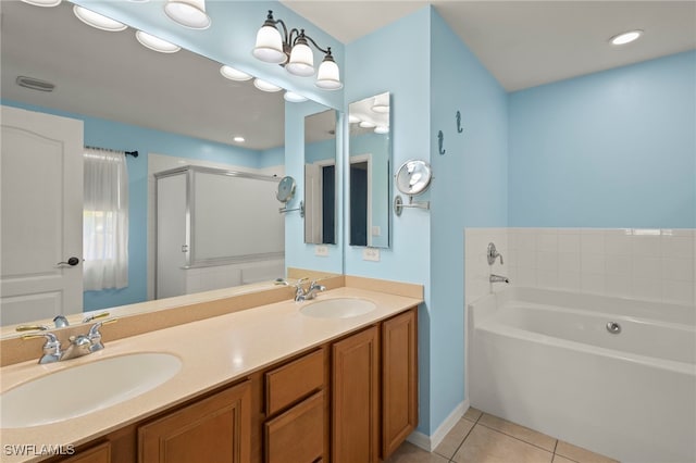 bathroom featuring double vanity, a garden tub, tile patterned flooring, and a sink