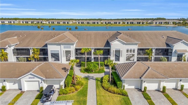 birds eye view of property with a water view