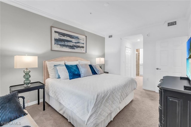 bedroom with light colored carpet, crown molding, and ensuite bathroom