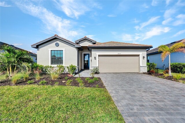 view of front of house featuring a garage and a front lawn