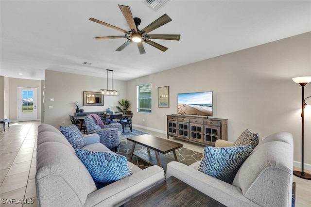 tiled living room featuring plenty of natural light and ceiling fan