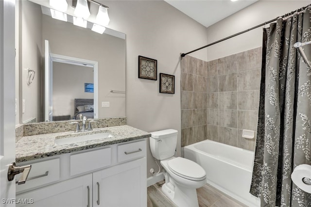 full bathroom with shower / tub combo, vanity, toilet, and hardwood / wood-style floors