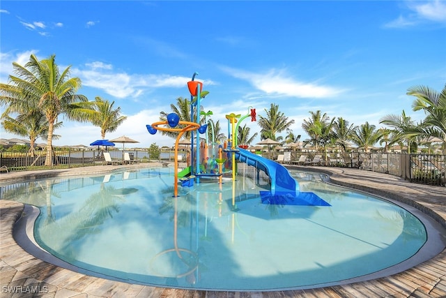 view of pool featuring a playground and a water slide